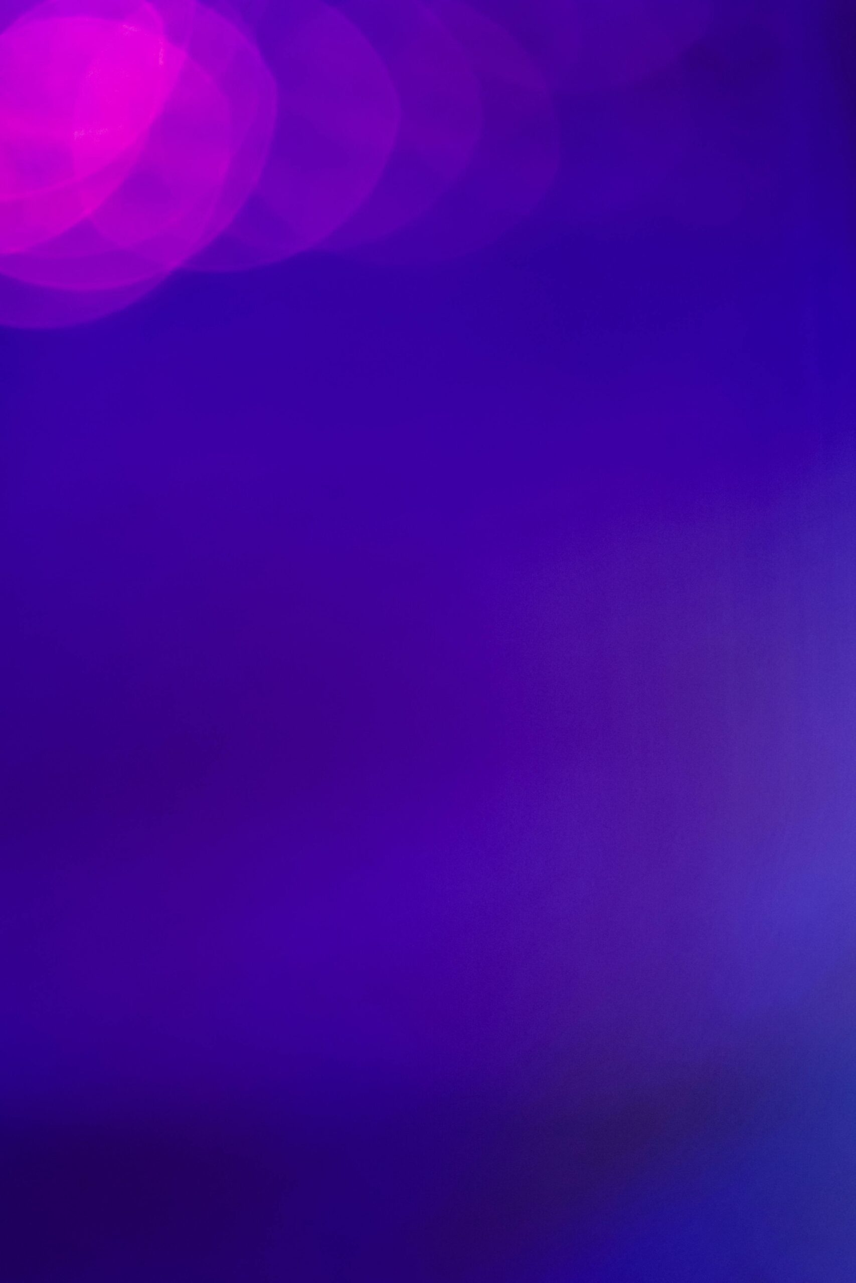 Vibrant abstract bokeh lights on a purple background, offering ample copy space for versatile use.